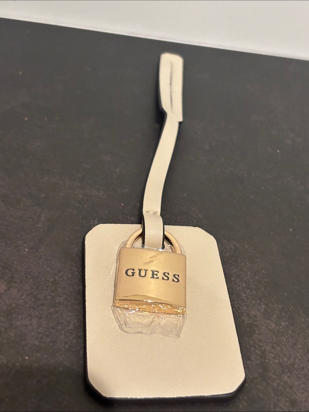 Guess Cream Leather Luggage Tag with Gold Padlock Charm